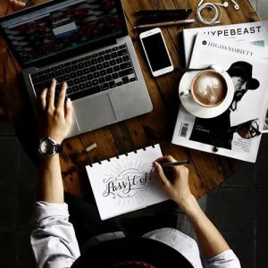 An individual works with a laptop and a coffee - possibly learning about the develop-ment opportunities Partner Electronics offers.